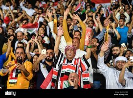 iraqi-football-fans-hold-up-their-national-flags-to-show-support-for-iraq-national-football-te...jpg