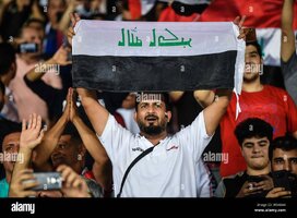 iraqi-football-fans-hold-up-their-national-flags-to-show-support-for-iraq-national-football-te...jpg